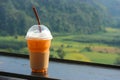 Thai iced tea in plastic cup with natural view as background Royalty Free Stock Photo