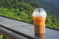 Thai iced tea in plastic cup with natural view as background Royalty Free Stock Photo