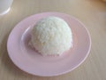 Thai jasmine rice cooked in a plate on a wooden table
