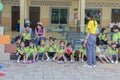 Thai kindergarten students are sitting in the Wanthamaria school to talk each other with their teachers assisted nearby. Pranburi