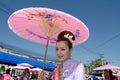 Thai Lady smile in parade of pedal a bicycle.