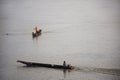 Thai and laos people riding long tail boat for catch fishing and reflection light surface water of Mekhong River and lighting of Royalty Free Stock Photo