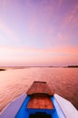 Thai wooden boat bow travel in peaceful Nong Harn lake - Udonthani, Thailand. Famous red lotus lake in winter Royalty Free Stock Photo