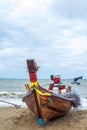 A Thai long-tail fishing boat on the beach looks like a colorful and exotic sight, is a traditional wooden boat with a long Royalty Free Stock Photo