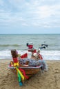 A Thai long-tail fishing boat on the beach looks like a colorful and exotic sight, is a traditional wooden boat with a long Royalty Free Stock Photo