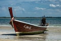 Thai Longboat beached on the sea