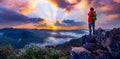 Thai male tourists stand on Phu Pha Mok mountain, Ban Jabo, Mae Hong Son Province, Thailand