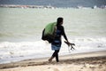 Thai man athletes walking on sand beach and carry kiteboard go to practicing sports and playing or sea kite at Ban Pae beach