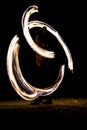 Thai man fire juggling at night on a beach of Koh Lipe island in Thailand