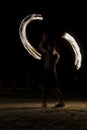 Thai man fire juggling at night on a beach of Koh Lipe island in Thailand