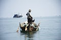 Thai man fisher people sailing wooden long tail boat fishery floating in sea use net catch fishing marine and fish in ocean at Mu Royalty Free Stock Photo