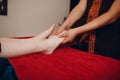 Thai man making classical feet thai massage procedure to young woman at beauty spa Royalty Free Stock Photo