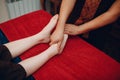 Thai man making classical feet thai massage procedure to young woman at beauty spa Royalty Free Stock Photo