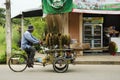 Thai man people riding tricycle cart for sale equipment and housekeeping tool on the road