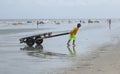 Thai man pulling a rickshaw on the beach of Si Racha