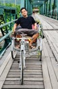 Thai Man sit at Riding tricycle on Bridge over Pai Rive of Mae Hong Son Thailand Royalty Free Stock Photo