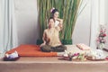 Thai Masseuse doing massage for lifestyle woman in spa salon. Asian beautiful woman getting Thai herbal massage compress massage i Royalty Free Stock Photo