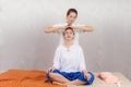 Thai Masseuse doing massage for woman in spa salon. Asian beautiful woman getting thai herbal massage