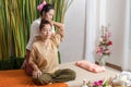 Thai Masseuse doing massage for woman in spa salon. Asian beautiful woman getting