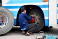 Thai mechanic people repairing and fix change wheel tire of bus Royalty Free Stock Photo