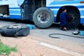 Thai mechanic people repairing and fix change wheel tire of bus Royalty Free Stock Photo