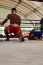 Thai men boxer punch kickboxing match with foreign fighter on boxing ring in event Thai Boxing Wai Khru Ceremony and world muay Royalty Free Stock Photo