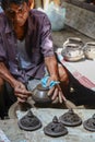 Thai men working with local craftsman making pottery