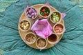 A Thai Miang kham bua lhuang platter with lotus flower petal wraps & a wide variety of ingredients, on a decorative place mat
