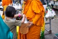 Thai monk ask for alms for buddhist to make merit Royalty Free Stock Photo