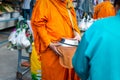 Thai monk ask for alms for buddhist to make merit Royalty Free Stock Photo