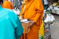 Thai monk ask for alms for buddhist to make merit Royalty Free Stock Photo