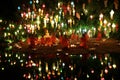Thai monks meditate around buddha statue among many lanterns