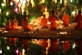 Thai monks meditate around buddha statue among many lanterns Royalty Free Stock Photo