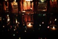 Thai monks meditate around buddha statue among many lanterns