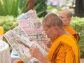 Thai monks read newspaper