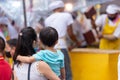 Thai mother bring their children to travel watching the cooking intently in Vegetarian Festival on Yaowarat Road. 18 October 2020