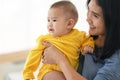 Thai mum is comforting a baby. woman holding a newborn baby in her arms Royalty Free Stock Photo