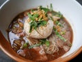 thai noddle of jumbo pork ball, pig liver, pork slide and vegetable on wooden table, hot noodle with blood pink for soup, in Thai Royalty Free Stock Photo