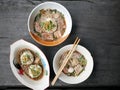 thai noddle of jumbo pork ball, pig liver, pork slide and vegetable on wooden table, hot noodle with blood pink for soup, in Thai Royalty Free Stock Photo