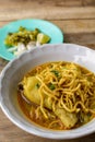 Thai Noodle Curry Soup with chicken on wooden table