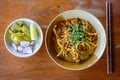 Thai Noodle Curry Soup with pork on wooden table