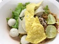 Thai noodle no soup serve with egg, lemon and pork ball and toppings with spicy. Thai street food. Royalty Free Stock Photo