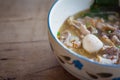 Thai noodle soup,Tom Yum in bowl on wooden background with copy space.