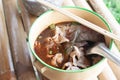 Thai noodles soup with pork in vintage bowl