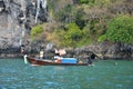 Thai old man fisher people sailing wooden long tail boat fishery use net catch fishing marine and fish in ocean of andaman sea Royalty Free Stock Photo