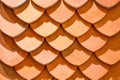 Thai old style rooftop pattern design, fish scales pattern, layer of red clay tiles roof texture background Royalty Free Stock Photo