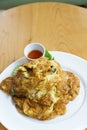 Thai Omelet with steamed rice on wood table background
