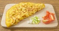 Thai Omelette with Tomatoes and Scallion on Cutting Board Royalty Free Stock Photo