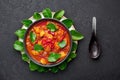 Thai Panang Chicken Curry in black bowl at dark slate background. Phanaeng Curry is Thai Cuisine dish Royalty Free Stock Photo