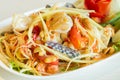 Thai papaya salad with field crab in white dish on the stone table